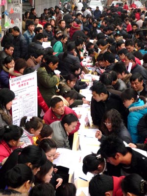 People search for job information at the job fair for migrant workers held in Huaiyuan County, east China's Anhui Province, on Feb. 4, 2009. Over 3,000 job vacancies of 120 local enterprises were provided to migrant workers at the job fair. (Xinhua/Ye Shengli)