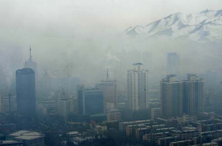 Buildings are shrouded by fog in Urumqi, capital of northwest China's Xinjiang Uygur Autonomous Region, Feb. 4, 2009. Heavy fog hit Urumqi on Wednesday, the fourth consecutive day this month. [Zhao Ge/Xinhua]