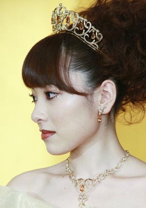 A model displays gold thread made wedding dresses, and tiaras, designed by Japanese designer Yumi Katsura, and priced 70 million Japanese Yen in Tokyo Feb. 4, 2009. (Xinhua/Ren Zhenglai)