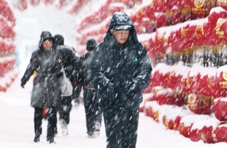 Residents walk in snow in Altay area in northwest China's Xinjiang Uygur Autonomous Region Feb. 5, 2009. A heavy snowfall hit Altay on Thursday. Local government has sent over 100 workers to the pasturing area to help herdsmen fight against chilliness. [Liu Xinhai/Xinhua] 
