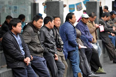 Migrant workers wait outside the Hangzhou Migrant Labour Force Market for jobs in Hangzhou, capital of east China's Zhejiang Province, Feb. 5, 2009. According to statistics of the market, the number of migrant workers looking for jobs in Hangzhou after Chinese traditional Spring Festival holidays is at the same level with those in 2008. (Xinhua/Wang Dingchang)