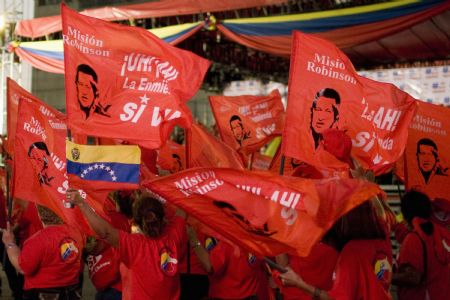 Supporters of Venezuelan President Hugo Chavez attend a military parade in Maracay February 4, 2009. Chavez and his supporters celebrated the 17th anniversary of a failed coup which forged his political reputation. 