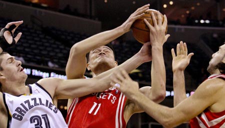 Memphis Grizzlies forward Darko Milicic (31) of Serbia tries to block a shot by Houston Rockets center Yao Ming (11) and Luis Scola (R) of Argentina in the first half of an NBA basketball game in Memphis, Tennessee February 4, 2009.