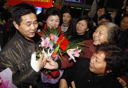 Wu Shougui (1st. L), one of Chinese tourists who suffered from a deadly bus crash accident last Friday in the United States, is welcomed by his relatives and friends upon his arrival at the Shanghai Pudong International Airport, east China's Shanghai municipality, Feb. 5, 2009.