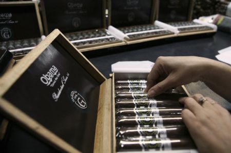 A worker makes the finishing touches to Obama cigar boxes at the Segovia cigar factory in Nicaragua's northern province of Esteli February 4, 2009.