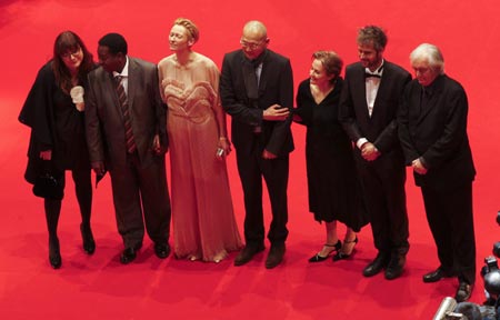 The jury for the 59th Berlinale (L-R) Isabel Coixet, Gaston Kabore, Tilda Swinton, Wayne Wang, Alice Waters, Christoph Schlingensief and Henning Mankell pose as they arrive at the red carpet for the screening of the opening film 'The International' at the 59th Berlinale film festival in Berlin February 5, 2009.