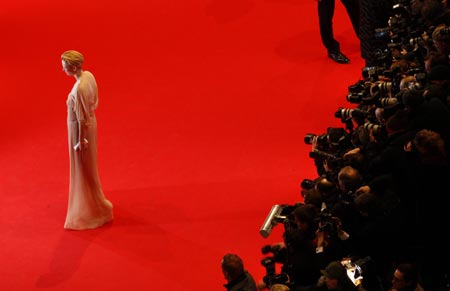 Jury member Tilda Swinton poses as she arrives at the red carpet for the screening of the opening film 'The International' at the 59th Berlinale film festival in Berlin February 5, 2009.