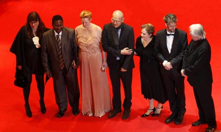 The jury for the 59th Berlinale (L-R) Isabel Coixet, Gaston Kabore, Tilda Swinton, Wayne Wang, Alice Waters, Christoph Schlingensief and Henning Mankell pose as they arrive at the red carpet for the screening of the opening film 'The International' at the 59th Berlinale film festival in Berlin February 5, 2009. 