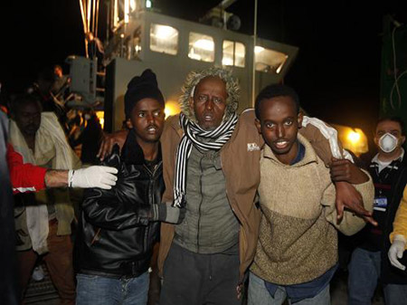 Would-be immigrants disembark from an Armed Forces of Malta (AFM) patrol boat at the AFM Maritime Squadron base at Haywharf in Valletta's Marsamxett Harbour February 5, 2009. 115 would-be immigrants were rescued by the AFM 48 nautical miles from Malta when their boat ran into difficulties while on its way to reach European soil from Africa, authorities said.