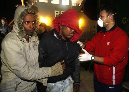 Would-be immigrants disembark from an Armed Forces of Malta (AFM) patrol boat at the AFM Maritime Squadron base at Haywharf in Valletta's Marsamxett Harbour February 5, 2009. 115 would-be immigrants were rescued by the AFM 48 nautical miles from Malta when their boat ran into difficulties while on its way to reach European soil from Africa, authorities said.