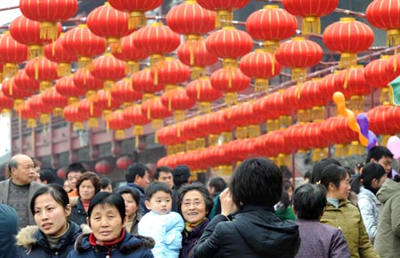 People walk under the red lanterns as they visit the Confucius Temple in Nanjing, capital of east China's Jiangsu Province, Feb. 6, 2009, ahead of the Chinese traditional Lantern Festival, which falls on the 15th day of the first month of a year of the Chinese lunar calendar, or Feb. 9 this year.[Xinhua]