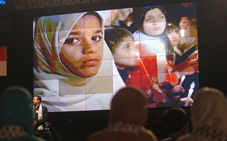  A documentary of Palestinian children is shown during a charity event aimed to help Palestinian children and women, in Jakarta, capital of Indonesia, Feb. 5, 2009. The money donated in the event will be used to buy medicine and medical equipments for the Palestinians. [Yue Yuewei/Xinhua]