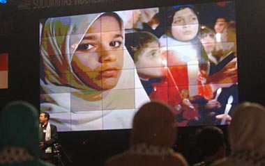 A documentary of Palestinian children is shown during a charity event aimed to help Palestinian children and women, in Jakarta, capital of Indonesia, Feb. 5, 2009. The money donated in the event will be used to buy medicine and medical equipments for the Palestinians. [Yue Yuewei/Xinhua]