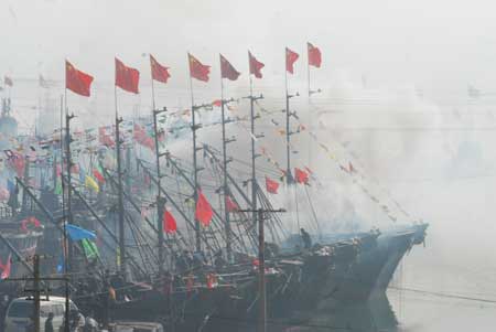 Fishing boats returned into the wharf to celebrate Fishing Lamp Day in the fishing harbor of Chuwang Village in Yantai city of east China's Shandong Province, Feb. 7, 2009. Local fishermen celebrate the festival on the 13th day of the first month of the Chinese Lunar Year, annually to pray for a good year. 