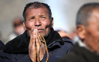 A Tibetan man prays during the Buddha Unveiling Festival in Labrang Lamasery in Xiahe County, Gannan Tibetan Autonomous Prefecture, northwest China's Gansu Province, Feb. 7, 2009.