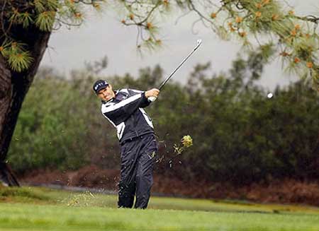 Ireland's Padraig Harrington hits out of the rough on the 13th fairway of the South Course at Torrey Pines in the second round of the Buick Invitational in San Diego on Friday.