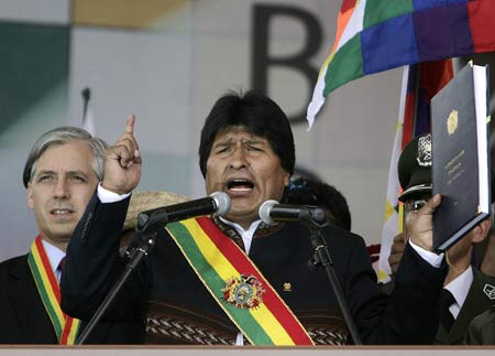 Bolivian President Evo Morales holds the new Bolivian Constitution while addresses supporters during the promulgation of the new Constitution in El Alto, Bolivia, on Feb. 7, 2009. 