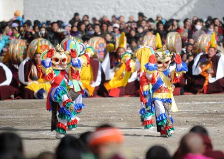 Tibetan Buddhists perform during the annual Buddhism dancing festival at the Labrang Temple in Xiahe County, northwest China's Gansu Province, Feb. 8, 2009. Monks of the Labrang Temple belonging to the Tibetan Buddhism's Geru Sect perform religionary dance on Sunday to pray for peace and happiness. (Xinhua/Nie Jianjiang)