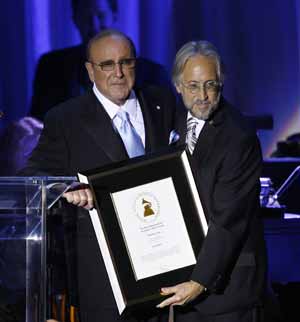 President of the National Academy of Recording Arts and Sciences Neil R. Portnow (R) presents Clive Davis with a special award at the 2009 Grammy Salute to Industry Icons in Beverly Hills, California February 7, 2009.