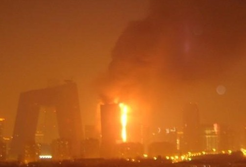 Located near Jingguang Bridge road, a newly-built structure within China's Central Television compound is ablaze in Beijing at 9 p.m. on Monday, February 9, 2009. Traffic police are controlling traffic around nearby roads. 