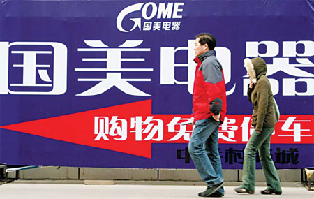 Pedestrians walk past a road sign leading to a Gome store in Beijing in this file photo. Gome is looking to raise capital in Hong Kong in a proposed private placement of new shares to institutional investors. 
