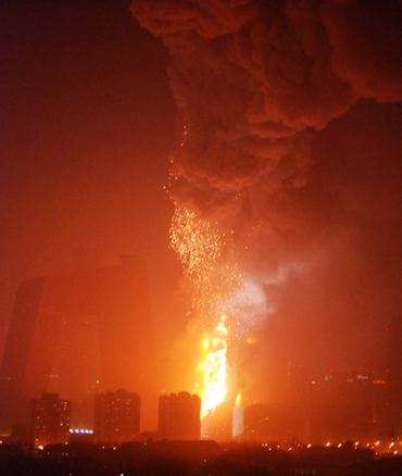 Located near Jingguang Bridge road, a newly-built structure within China's Central Television compound is ablaze in Beijing at 9 p.m. on Monday, February 9, 2009. Traffic police are controlling traffic around nearby roads.