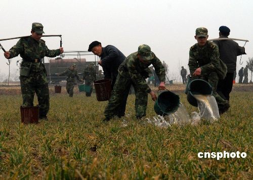 Soldiers helped farmers irrigate crops in Henan Province.