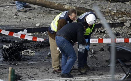 Police investigate the scene of a car bomb in Madrid, February 9, 2009.