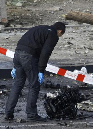 Police investigate the scene of a car bomb in Madrid, February 9, 2009.