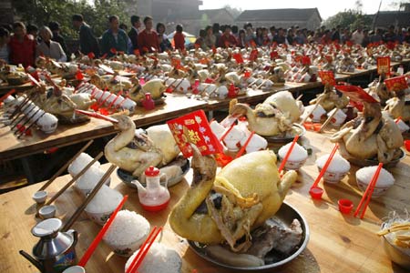 Local villagers watch a traditional chicken banquet dedicated to the God of Heaven ahead of the Lantern Festival at a village in Zhanjiang, south China's Guangdong Province Feb. 8, 2009. 