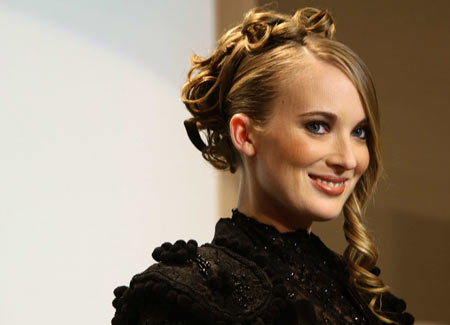 A model displays a creation by hair stylist Josep Pons during the presentation of a new line of 'Texture Expert' hair products from L'Oreal in central Barcelona February 9, 2009. The grid lines are caused by a light projection at the show. 