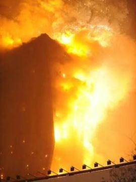 The photo taken on Feb. 9, 2009 shows the ablaze north wing building of the new CCTV (China Central Television) headquarters in Beijing, capital of China. A fire broke out on Monday night at the building, namely Mandarin Oriental Hotel, which is about hundreds of meters away from the new CCTV main tower in east Beijing. [Li Wen/Xinhua]