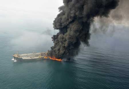 Smoke billows into the sky off the coast of Dubai after two ships collided causing a fire Feb.10, 2009.