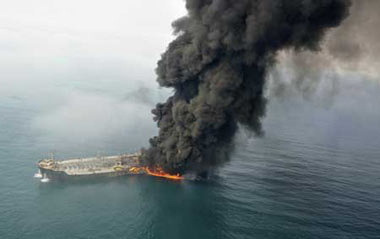 Smoke billows into the sky off the coast of Dubai after two ships collided causing a fire Feb.10, 2009.