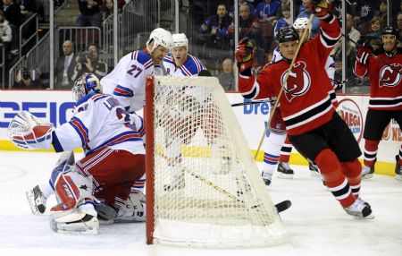 New Jersey Devils center Bobby Holik (R) reacts after he scored past New York Rangers goalie Henrik Lundqvist (L) in the second period of their NHL hockey game in Newark, New Jersey, February 9, 2009. 