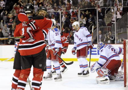 New Jersey Devils center Bobby Holik (L) is hugged by teammate winger Brendan Shanahan after he scored past New York Rangers goalie Henrik Lundqvist (R) in the second period of their NHL hockey game in Newark, New Jersey, February 9, 2009. 