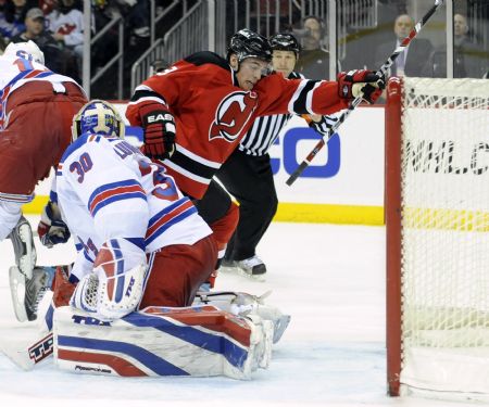 New Jersey Devils winger Zach Parise (R) reacts after he shot past New York Rangers goalie Henrik Lundqvist (30) to score a goal in the second period of their NHL hockey game in Newark, New Jersey, February 9, 2009.