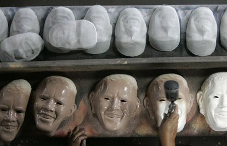 A worker puts finishing touches to masks made in the likeness of U.S. President Barack Obama at a costume factory assembly line in a suburb of Rio de Janeiro February 10, 2009. A total of 12,000 Obama masks will be made for the upcoming 'Brazil Carnaval' festival from February 20 to 22, according to the manufacturer.