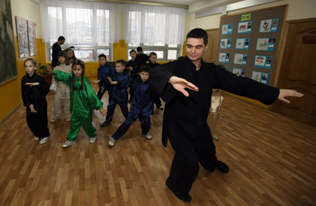 Students perform Chinese Taiji following their teacher at the Chinese festival held by Moscow 1948 Middle School in Moscow, capital of Russia, Feb. 10, 2009. 