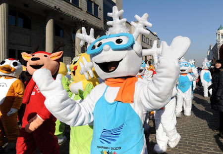 Volunteers wearing the outfits of snow doll 'Dongdong', the official mascot of the 2009 World Winter University Games, take part in a parade on the street at the 10-day countdown to the Games in Harbin, northeast China's Heilongjiang Province, February 9, 2009. [Xinhua]