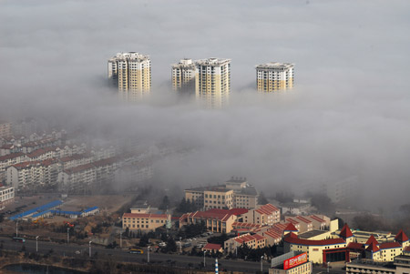 Photo taken on Feb. 11, 2009 shows the fog-wrapped buildings in Yantai City, east China's Shandong Province. An advection fog hit Yantai on Wednesday. [Xinhua] 