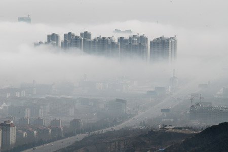 Photo taken on Feb. 11, 2009 shows the fog-wrapped buildings in Yantai City, east China's Shandong Province. An advection fog hit Yantai on Wednesday. [Xinhua]