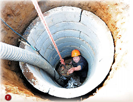 A villager works down a new well being drilled to combat the drought in Baishu town, Henan province, last week. [Gao Shanyue/China Daily] 