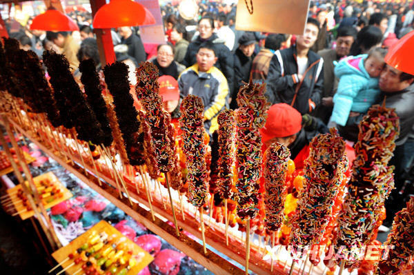 A fair exhibiting various candy products in Qingdao, Shandong Province, has drawn nearly eighty thousand citizens to the sweet atmosphere on February 10, 2009. The fair, with a history of over five hundred years, has put on display sweets from home and abroad such as Tanghulu, or crystalline sugar-coated haws on a stick and various chocolate products. [Photo: Xinhuanet]