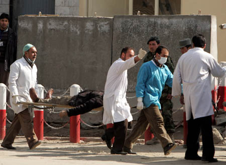 Afghan medics carry a wounded man from the Justice Ministry after suicide bombers attacked the building in Kabul, capital of Afghanistan, on Feb. 11, 2009. A series of terrorism attacks targeting several government buildings Wednesday morning killed at least 19 people and wounded 54 others, according to Public Health Ministry spokesman Abdul Fahim. The Taliban has claimed responsibility for the attacks. (Xinhua/Zabi Tamanna)