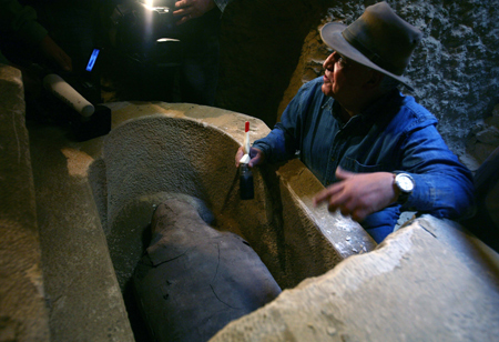 Zahi Hawass, Secretary General of the Egyptian Supreme Council of Antiquities, introduces a newly-opened limestone sarcophagus for journalists at Saqqara, 30 km south of Cairo, capital of Egypt, on Feb. 11, 2009.