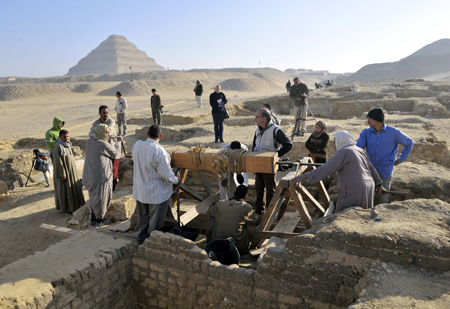 Workers and Journalists wait outside a burial chamber at Saqqara, 30km south of Cairo, capital of Egypt, on Feb. 11, 2009.