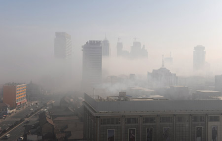 Photo taken on Feb. 11, 2009 shows the fog-wrapped buildings in Yantai City, east China's Shandong Province. An advection fog hit Yantai on Wednesday. (Xinhua Photo)