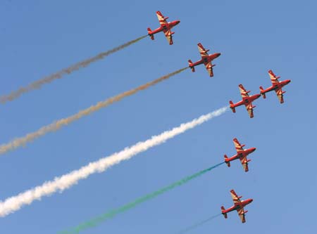 An Indian aerobatics team performs during the opening ceremony of an airshow in Bangalore, India, Feb. 11, 2009. The Aero India 2009 which opened here Wednesday attracted 592 firms from 25 countries and regions. 