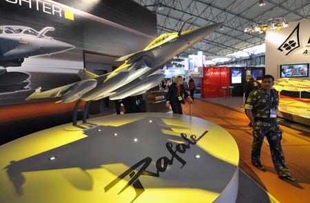 A visitor passes a battleplane model at an airshow in Bangalore, India, Feb. 11, 2009.